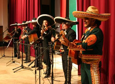 Mariachi el Mexicano on stage with red curtains