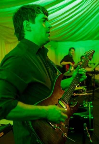 The Eddie Seales Band guitarist on stage with green lights