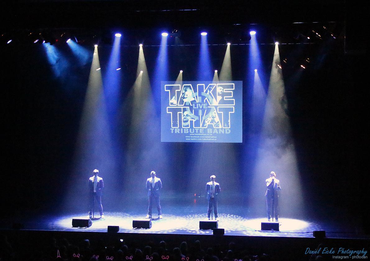 Take That LIVE tribute on stage with blue and white lights