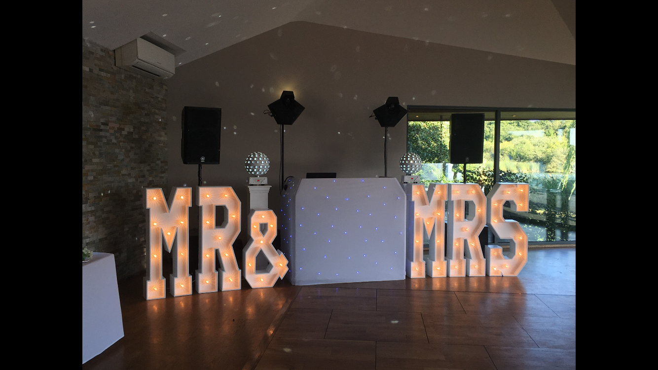 Mr & Mrs Letters set amongst Disco at boathouse