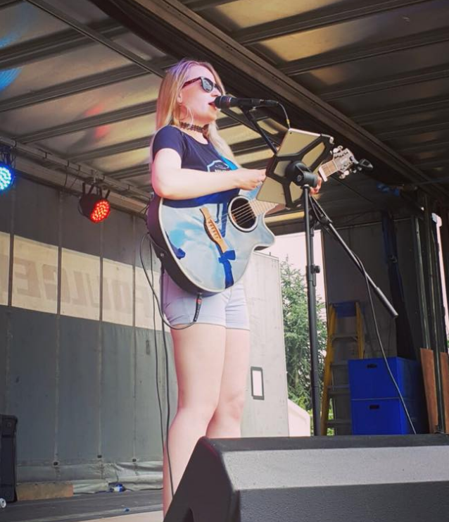 Singer Serena Grant playing at an outside festival