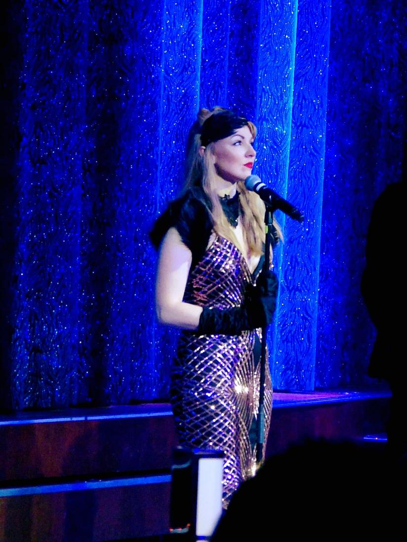 Ashlea Lauren Singer on stage with blue lighting