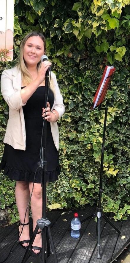 Vocalist Lucy Eleanor Kemp performing outside