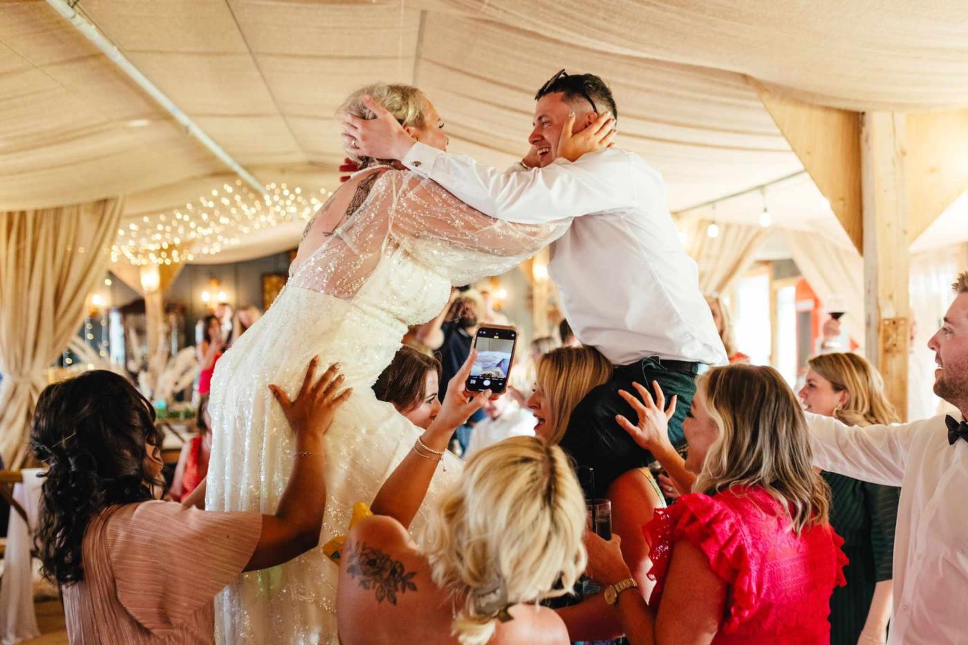 Bride & groom dancing to singing waiters