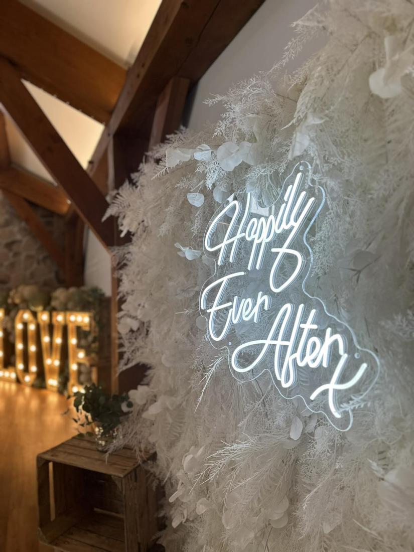 Feather wall  with neon Happily ever after sign