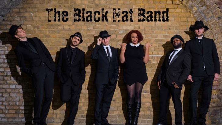 The Black Hat Band Leaning on a wall